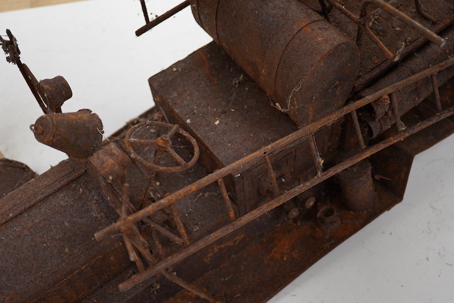 A skeleton of a toy vehicle 80cm long. Condition - rusty, without wheels